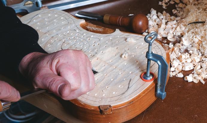 Working across maple back, held by solid jig.