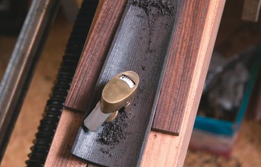 Fingerboard hollowed by toothed-blade thumb plane.