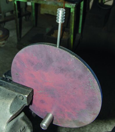 The stove plate complete with the handle designed to minimise heat