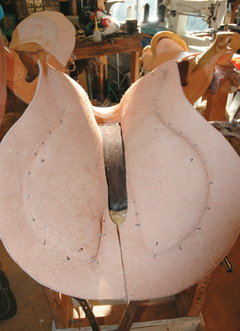 Hide tacked under the saddle