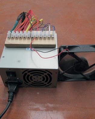 Cooling computer fan added as “load” which the power supply needs to function.
