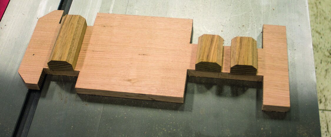 A rectangular block with wheel arches cut out. Chamfer  front and back and nipping corners away defines bumpers.