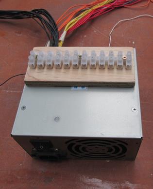 The 12-way connector block— “chocolate block”—screwed to a piece of ply and double-side taped on.