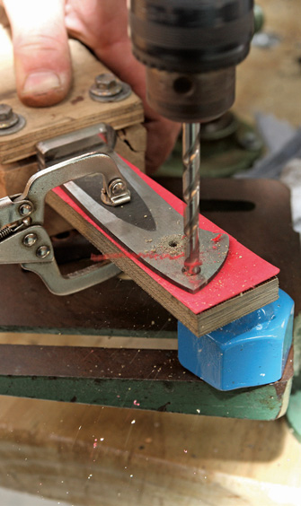 Box on blade holds tapered tang flat for drilling vertical hole