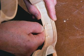 Trimming linings to a bevelled section.