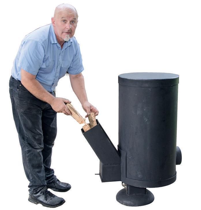 Stuart demonstrating howthe Rocket Stove feeds.