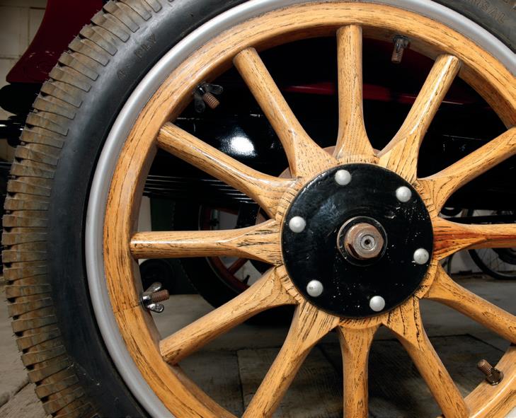 The oak wheels that have been made from scratch by Vern Jensen of Fielding. The wing nuts are unscrewed and lead washers added to balance the wheels. This system was also used on such cars as Bentley and Rolls Royce up to World War II. Roy King will…