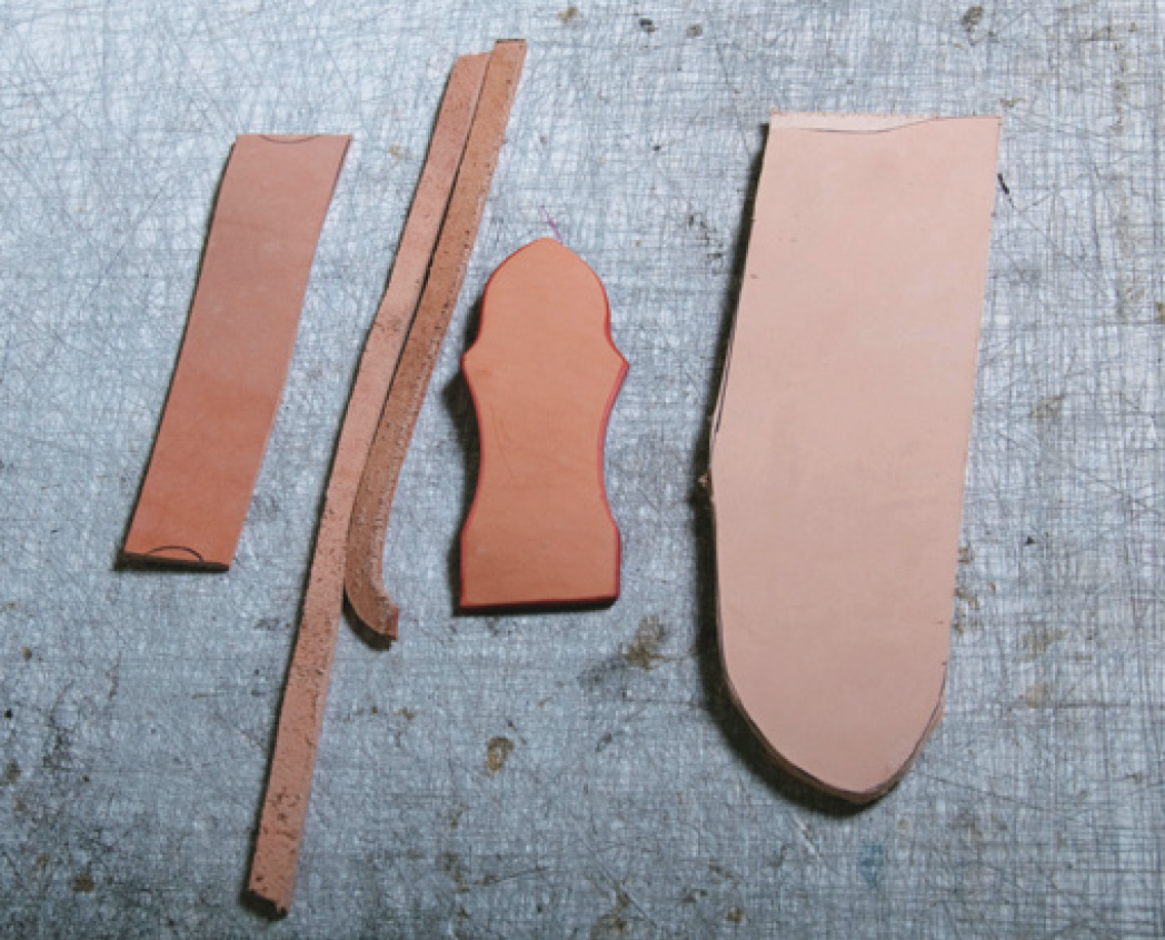 Leather pieces for (from left) sleeve for the steel, spacer strips, belt loop, sheath.