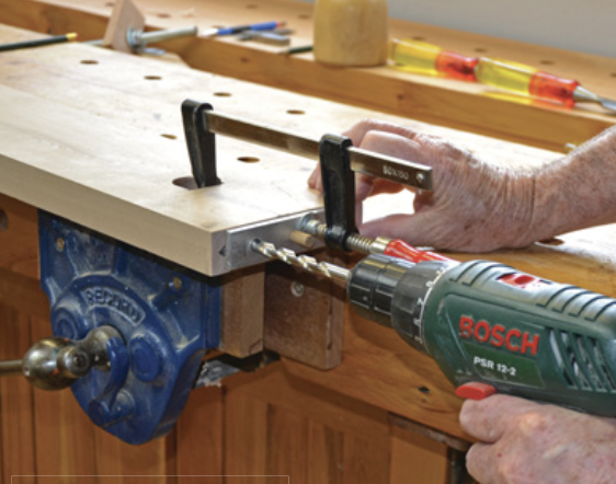 Drilling dowel holes in the side rail.