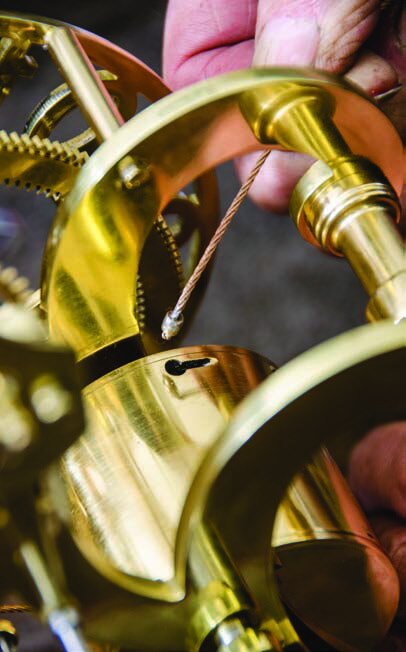 The end of the fusee wire fixed to the spring barrel