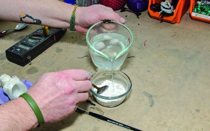 Mixing plaster with iced water to slow the reaction