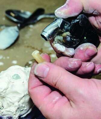 Adding a candle as a sprue for pouring the metal