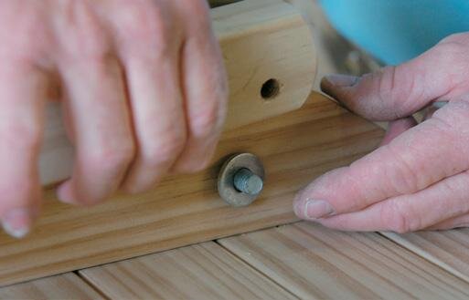 Fixing the moveable legs. Note the off-centre bolt hole