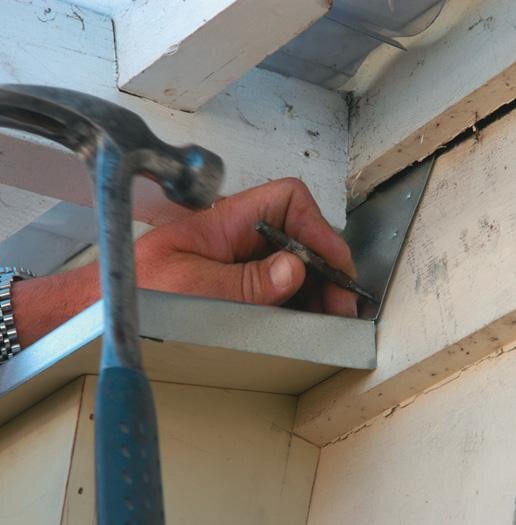 Flashing secured under weatherboard